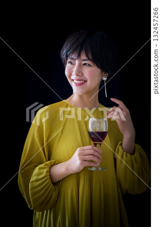 Nice woman with short hair drinking wine 132457266