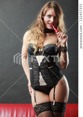 Woman wearing sexy lingerie holding chilli pepper 132457355