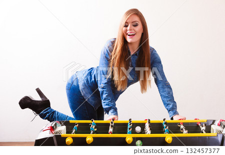 woman playing table football game 132457377