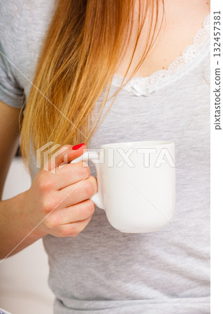 woman on bed with cup of coffee woman on bed with cup of coffee 132457381
