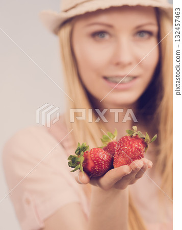 Girl showing fresh strawberries Girl showing fresh strawberries 132457463