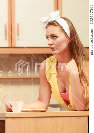 Pretty pin up girl drinking tea or coffee at home. Pretty pin up girl drinking tea or coffee at home. 132457592