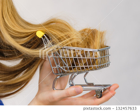Girl with her long hair in shopping cart 132457633