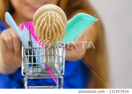 Girl with hair accessories in shopping cart 132457634
