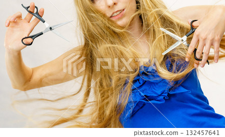 Girl with scissors for haircutting 132457641