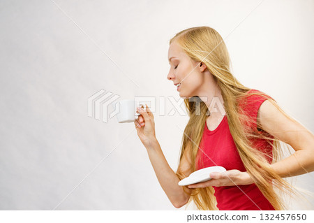 Blonde girl with coffee cup Blonde girl with coffee cup 132457650