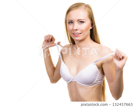 Young woman holding bra strap 132457663