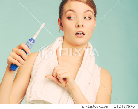 Young girl brushing oral cavity. 132457670