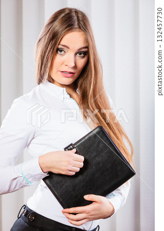 Young woman office worker hold case with files. Young woman office worker hold case with files. 132457730