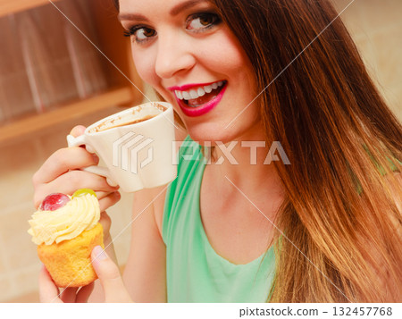 Woman drinking coffee and eating delicious cake. 132457768