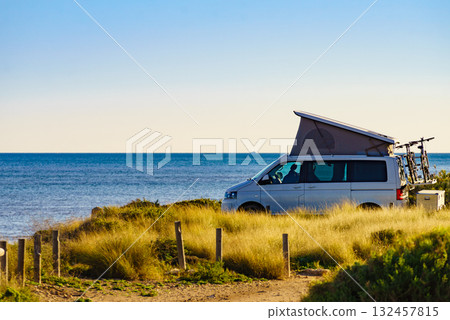Camper van with roof top tent camp on beach 132457815