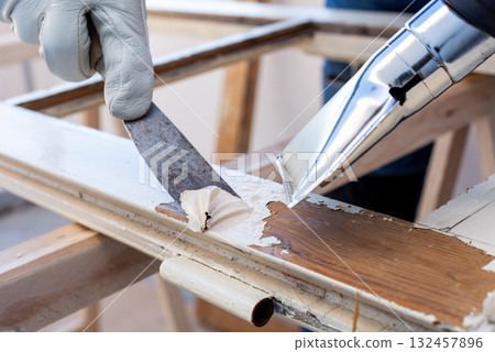 Carpenter at work, restoring an old wooden window. Carpentry. 132457896