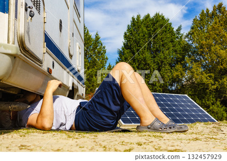 Man repairing bottom of the rv caravan Man repairing bottom of the rv caravan 132457929