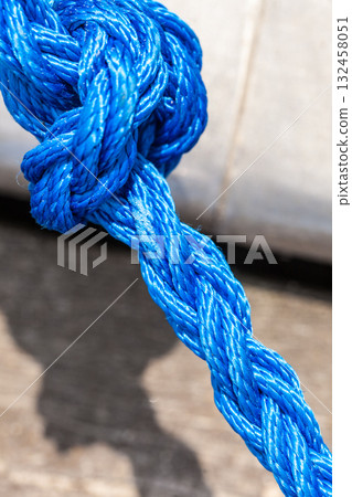 Blue sailing rope tied with knots Blue sailing rope tied with knots 132458051