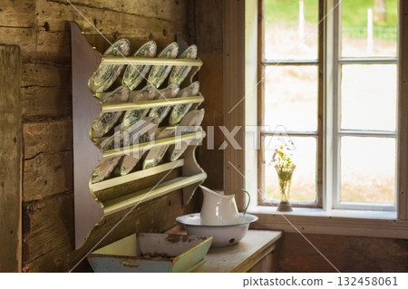 Vintage shelf with decorative plates in old cottage 132458061