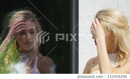 Elegant woman looking at shop window Elegant woman looking at shop window 132458200