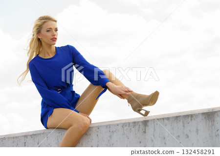 Fashion model wearing blue jumpsuit Fashion model wearing blue jumpsuit 132458291