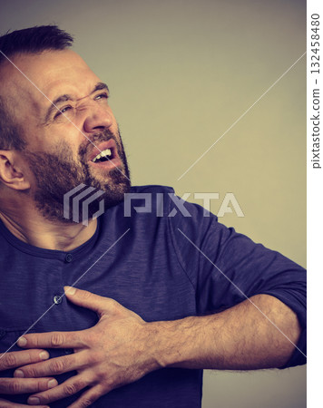 Man having heart pain attack Man having heart pain attack 132458480