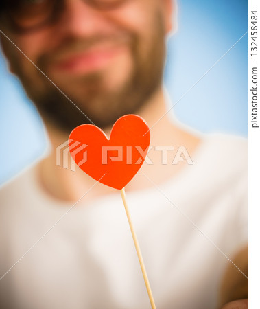 Adult man with heart on stick Adult man with heart on stick 132458484