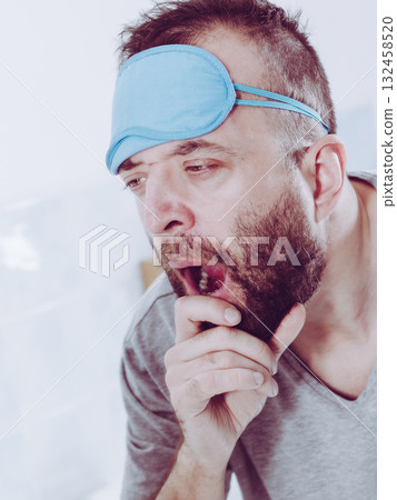 Sleepy man looking at mirror and yawning Sleepy man looking at mirror and yawning 132458520