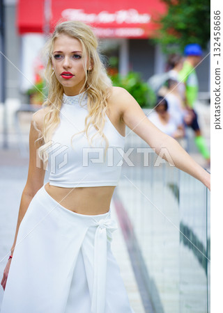 Woman wearing crop top and culottes Woman wearing crop top and culottes 132458686