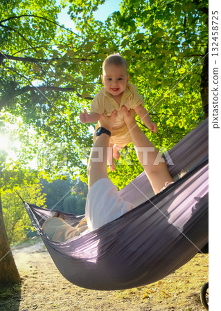 Parent and Baby Enjoying Hammock Time Outdoors 132458725