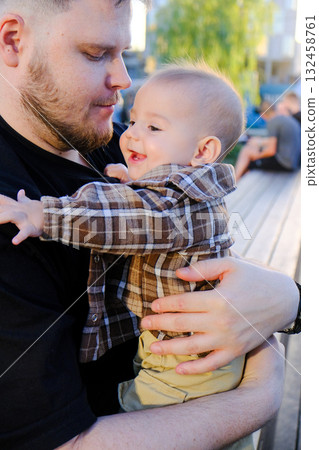 Father and Baby Smiling Outdoors 132458761