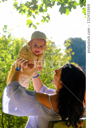 Mother and Baby Enjoying Sunny Day in Park 132458869