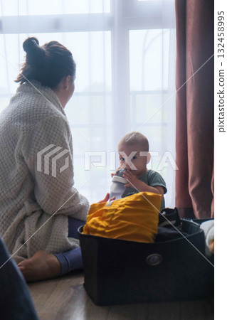 Mother and Baby by the Window 132458995
