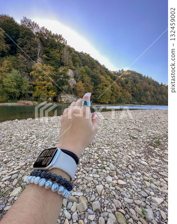 Hand Reaching Towards Rocky Cliff Across River Hand Reaching Towards Rocky Cliff Across River 132459002