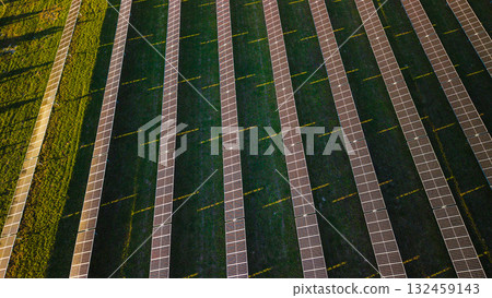 Aerial top view of modern solar power station with rows of photovoltaic panels generating renewable energy in sunlight. Aerial top view of modern solar power station with rows of photovoltaic panels generating renewable energy in sunlight. 132459143