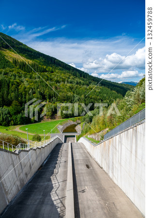 Panoramic view of the Sance reservoir and lake in summer, surrounded by green forests and blue sky, located near the Beskydy mountains in the Czech Republic. Panoramic view of the Sance reservoir and lake in summer, surrounded by green forests and blue sky, located near the Beskydy mountains in the Czech Republic. 132459788