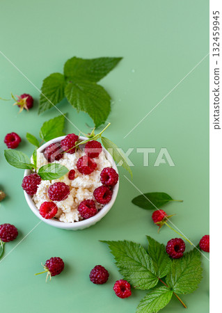 Healthy breakfast of cottage cheese with ripe raspberries 132459945