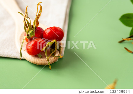 green background and harvest of red rose hips green background and harvest of red rose hips 132459954