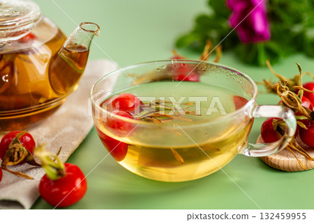hot tea in a cup of rose hips on a green background 132459955