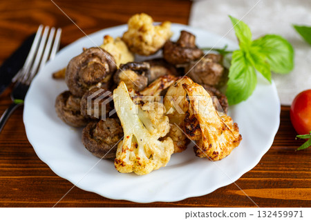 Roasted cauliflower and mushrooms served on white ceramic plate Roasted cauliflower and mushrooms served on white ceramic plate 132459971