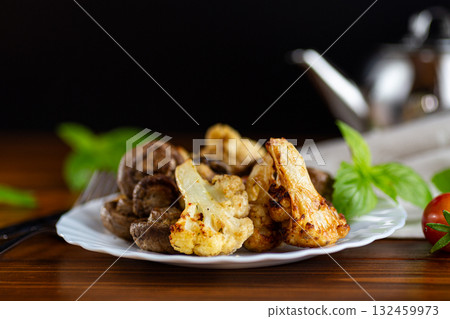 Healthy vegetarian meal with roasted cauliflower and mushrooms Healthy vegetarian meal with roasted cauliflower and mushrooms 132459973