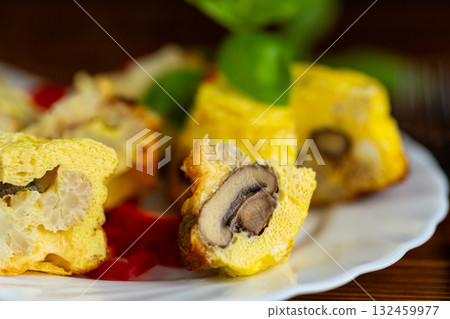 Tasty homemade omelet with cauliflower and mushrooms on table Tasty homemade omelet with cauliflower and mushrooms on table 132459977