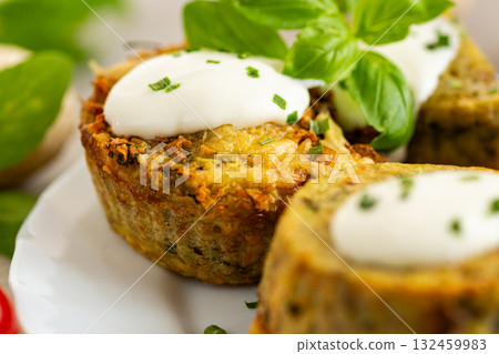 Homemade baked potato and mushroom cakes served with cream Homemade baked potato and mushroom cakes served with cream 132459983