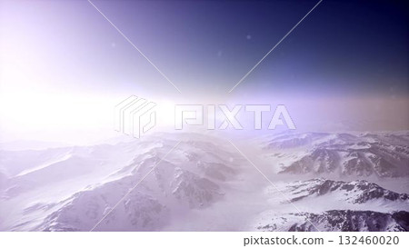 An endless expanse of snow covered mountains emerges beneath a gentle dawn light. The serene atmosphere suggests a peaceful, untouched wilderness, inviting exploration and adventure. An endless expanse of snow covered mountains emerges beneath a gentle dawn light. The serene atmosphere suggests a peaceful, untouched wilderness, inviting exploration and adventure. 132460020