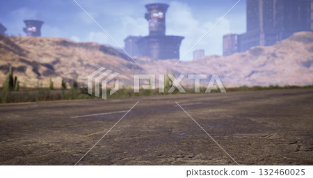 A desolate roadway stretches through a barren landscape where ruins emerge in the distance. Scrub vegetation dots the terrain under a clear blue sky and towering mountains. 132460025