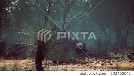 Lush greenery surrounds a mysterious creature partially hidden among the foliage during twilight hours. The tranquil setting evokes curiosity and wonder in natures realm. 132460041