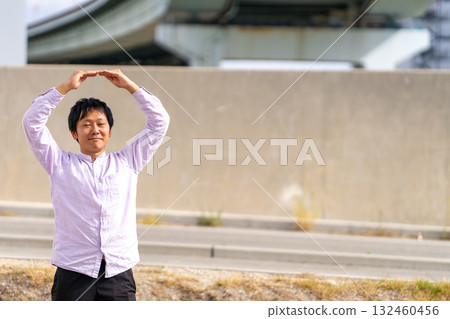 Smiling man making a circle with his hand to indicate "OK" | Man in a pose expressing business approval, permission, and permission Smiling man making a circle with his hand to indicate "OK" | Man in a pose expressing business approval, permission, and permission 132460456