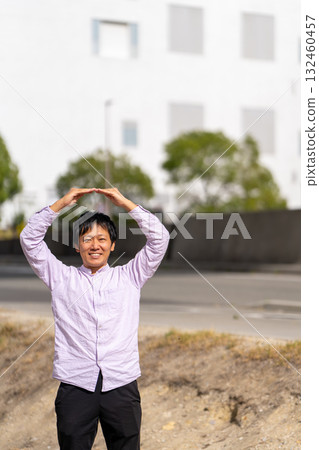 Smiling man making a circle with his hand to indicate "OK" | Man in a pose expressing business approval, permission, and permission Smiling man making a circle with his hand to indicate "OK" | Man in a pose expressing business approval, permission, and permission 132460457