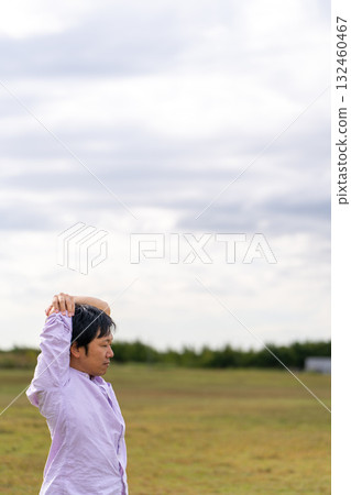Man stretching in the square | Copy space 132460467