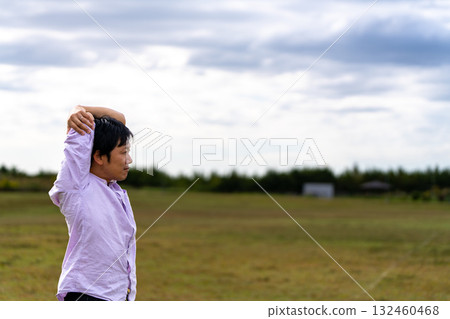 Man stretching in the square | Copy space 132460468