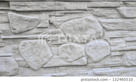 A fence or concrete wall, natural texture. Ivy climbs over the concrete surface. 132460510