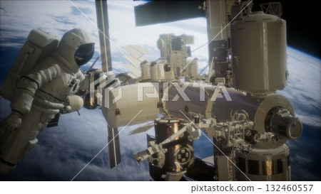 An astronaut is skillfully maneuvering outside the International Space Station, with Earth illuminated in the background. The moment encapsulates the beauty and vastness of space exploration. 132460557