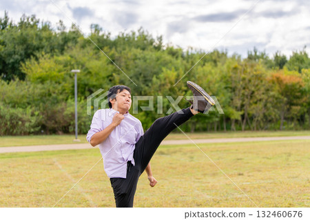 Man stretching with leg raised | Dynamic warm-up Man stretching with leg raised | Dynamic warm-up 132460676
