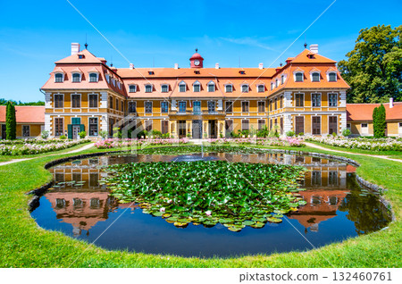 Panoramic view of Rajec Jestrebi Chateau on a sunny summer day with blue sky, blooming pink roses, and a fountain in front of the historical building. Panoramic view of Rajec Jestrebi Chateau on a sunny summer day with blue sky, blooming pink roses, and a fountain in front of the historical building. 132460761